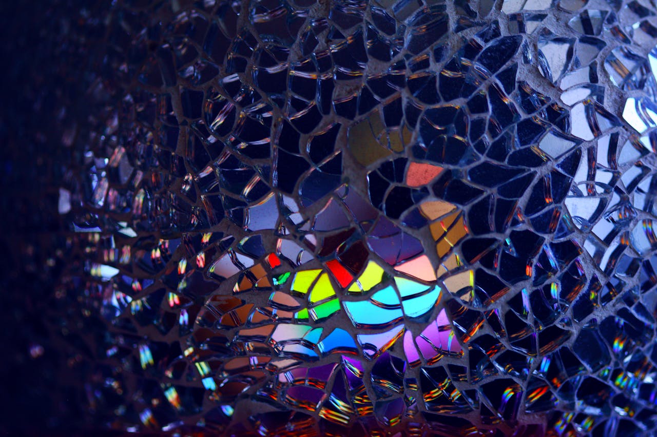 get-in-touch A colorful rainbow reflection through broken glass, creating an artistic and abstract effect.